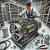 DALL·E 2024-11-16 19.54.43 - Ultra-realistic image of a professional serviceman working on an industrial screw compressor with accurate internal details. The screw compressor is o.webp